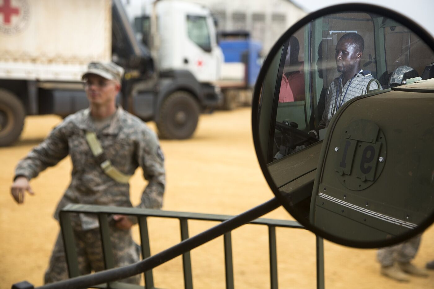 An instructor briefing a trainee beside a forklift